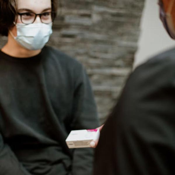 handing hair loss medication to patient