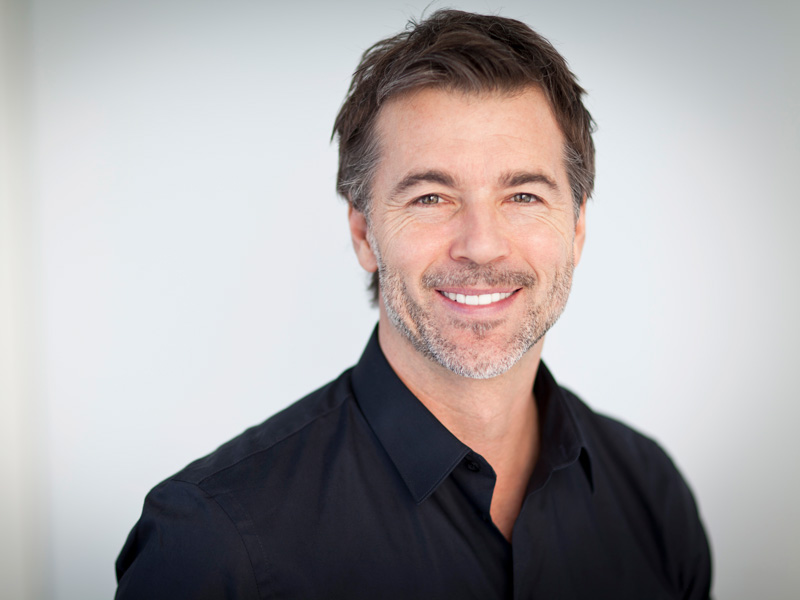 Man wearing a LaserCap® for advanced hair and skin treatments in the Greater Edmonton Area