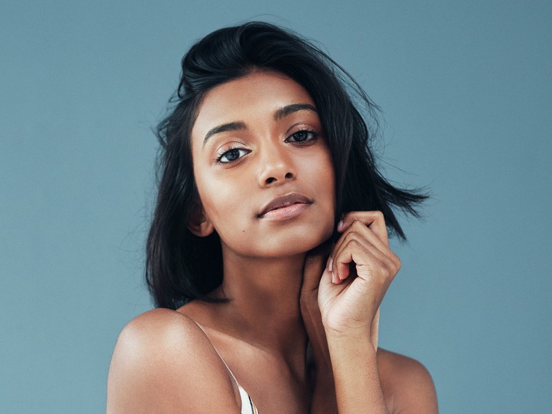A young woman gazes thoughtfully after receiving Plexr treatment in the greater Edmonton area