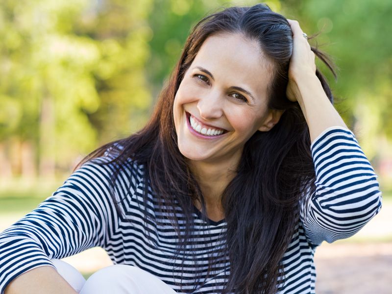 A joyful woman beams after Plexr treatment at Advanced Hair and Skin Surgery in greater Edmonton